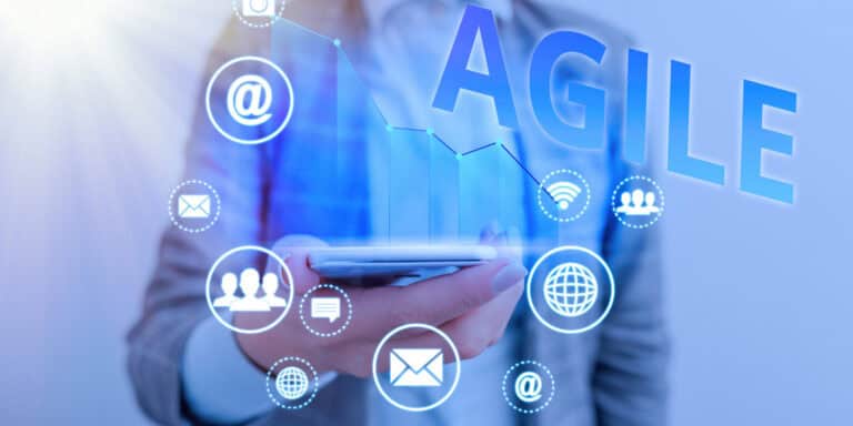 A man holding a phone with the word agile on it.