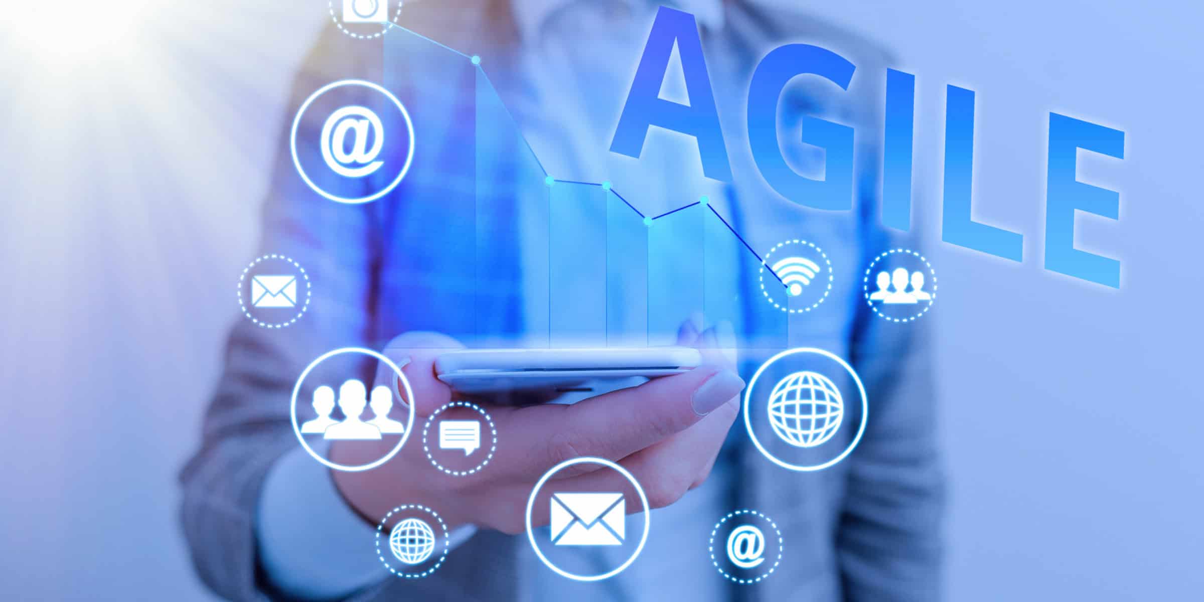 A man holding a phone with the word agile on it.
