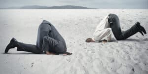 businessmen head in sand