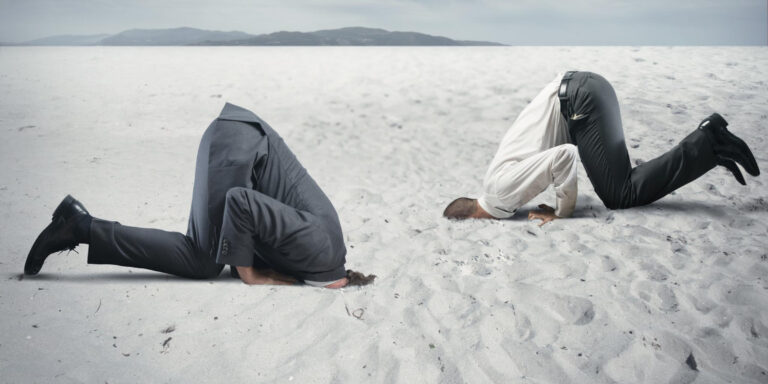 businessmen head in sand