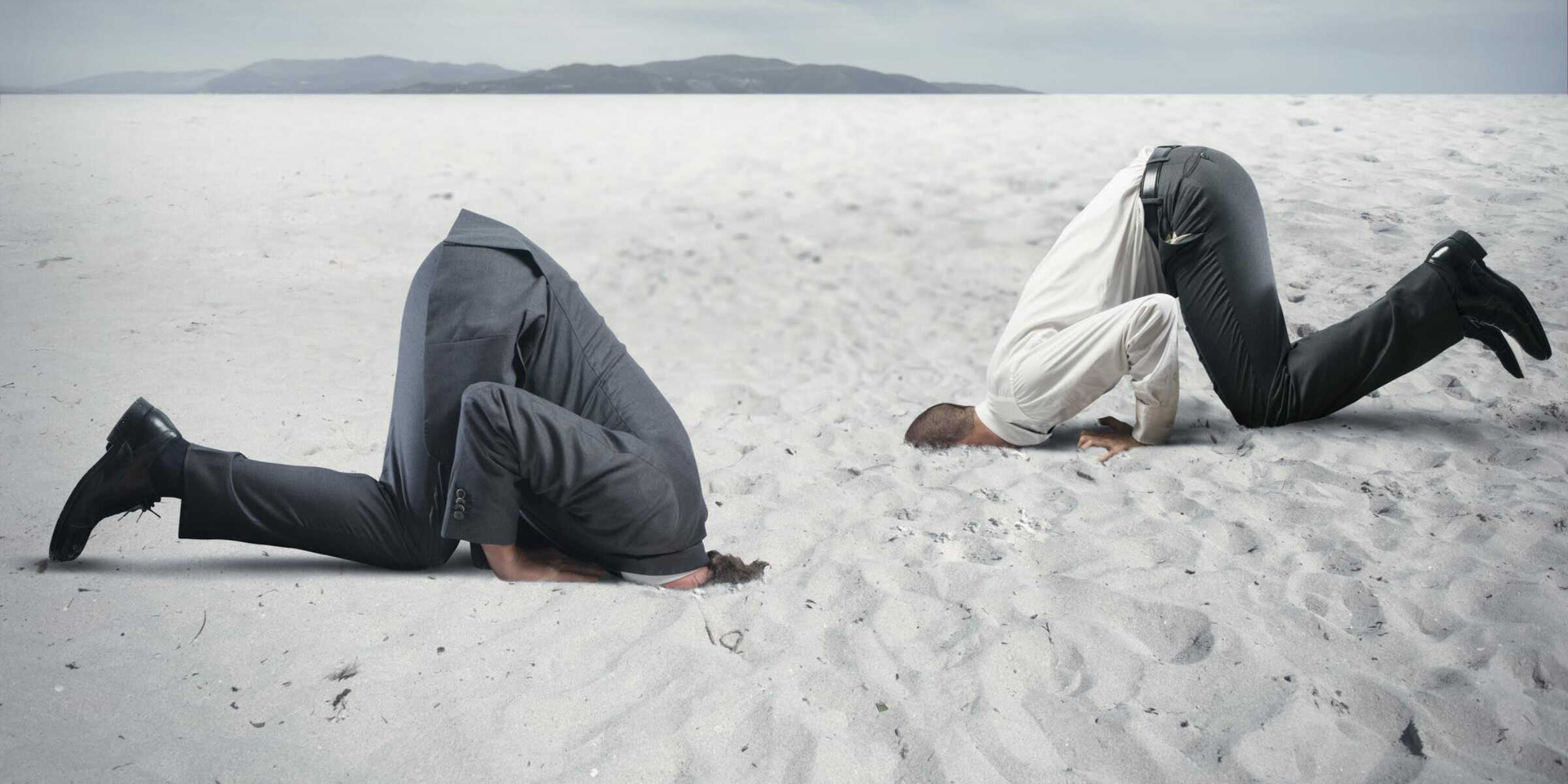 businessmen head in sand