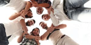 A group of people standing together in a circle.