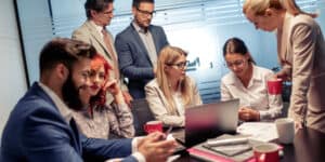 A group of business people sitting around a table.