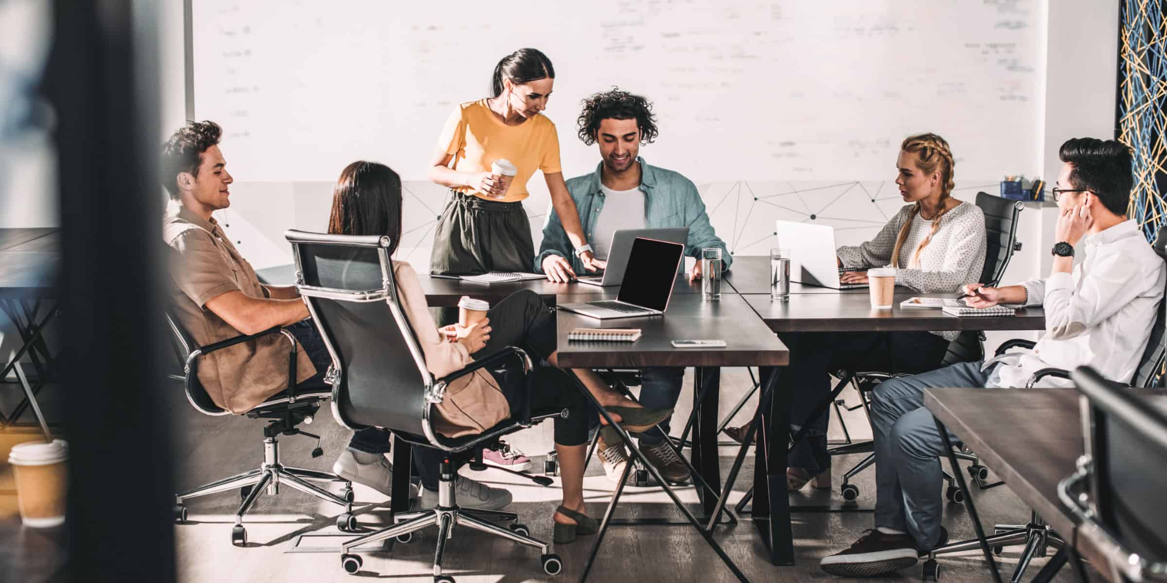 A group of people sitting around a table in an office.
