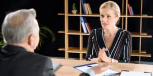 man and woman talking at work