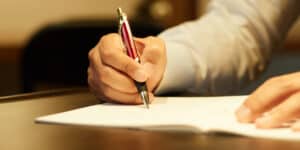 pen writing on paper.