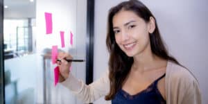 woman standing at project board.