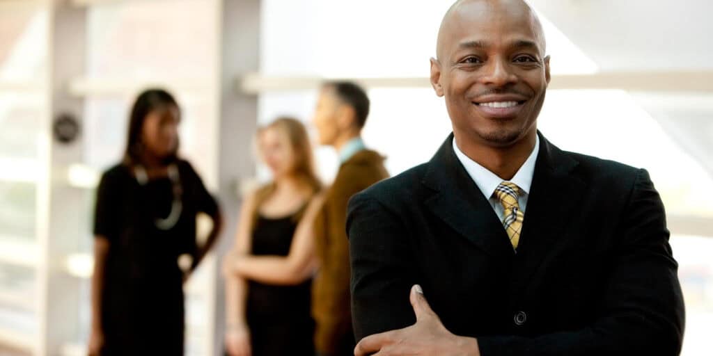 happy businessman in front of team