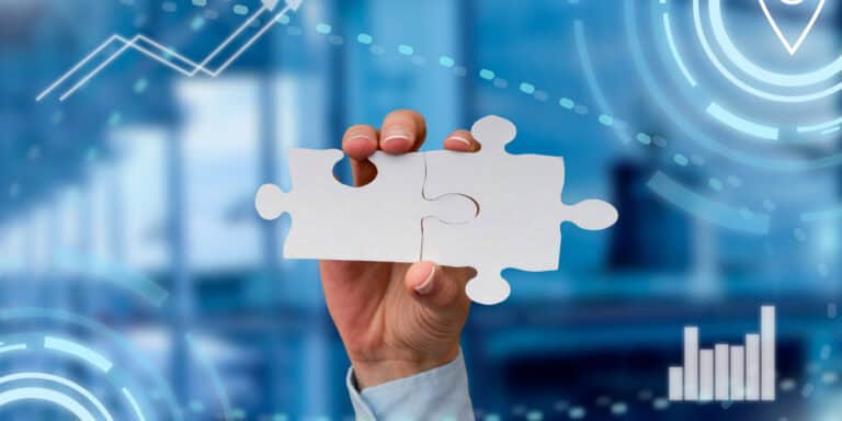 A person holding a piece of jigsaw puzzle.