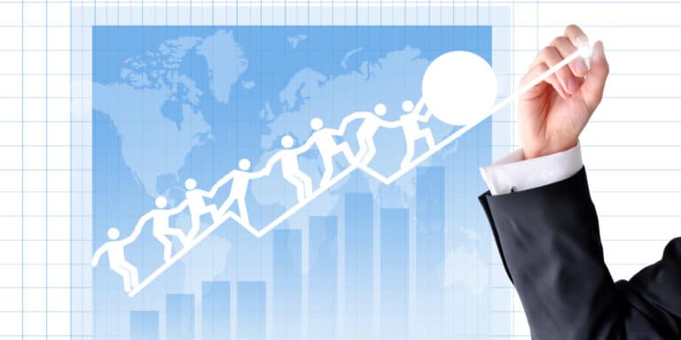 A businessman drawing a graph with people on it.
