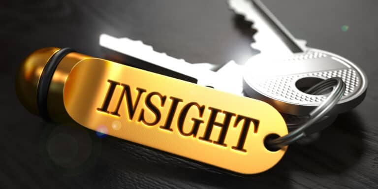 A gold key chain with the word insight on it.