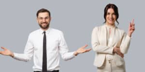 Two business people posing with their hands outstretched.