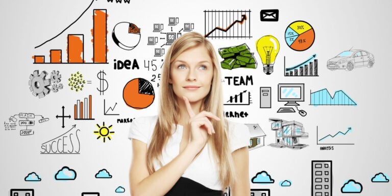A woman is looking at a wall with business icons drawn on it.