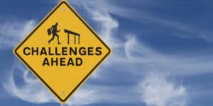 A yellow sign that says challenges ahead.