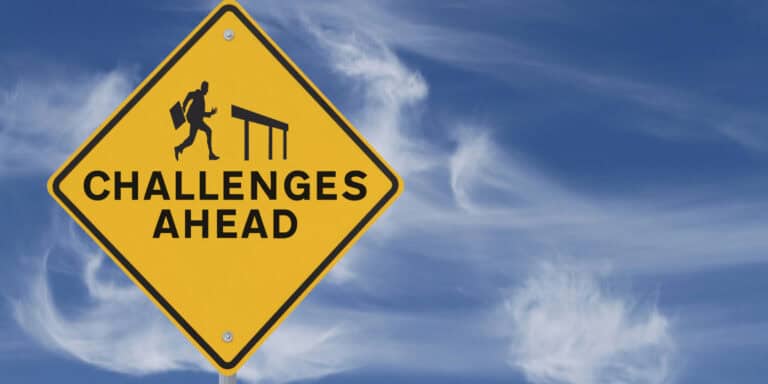 A yellow sign that says challenges ahead.