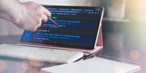 A person typing on a tablet computer with a keyboard.