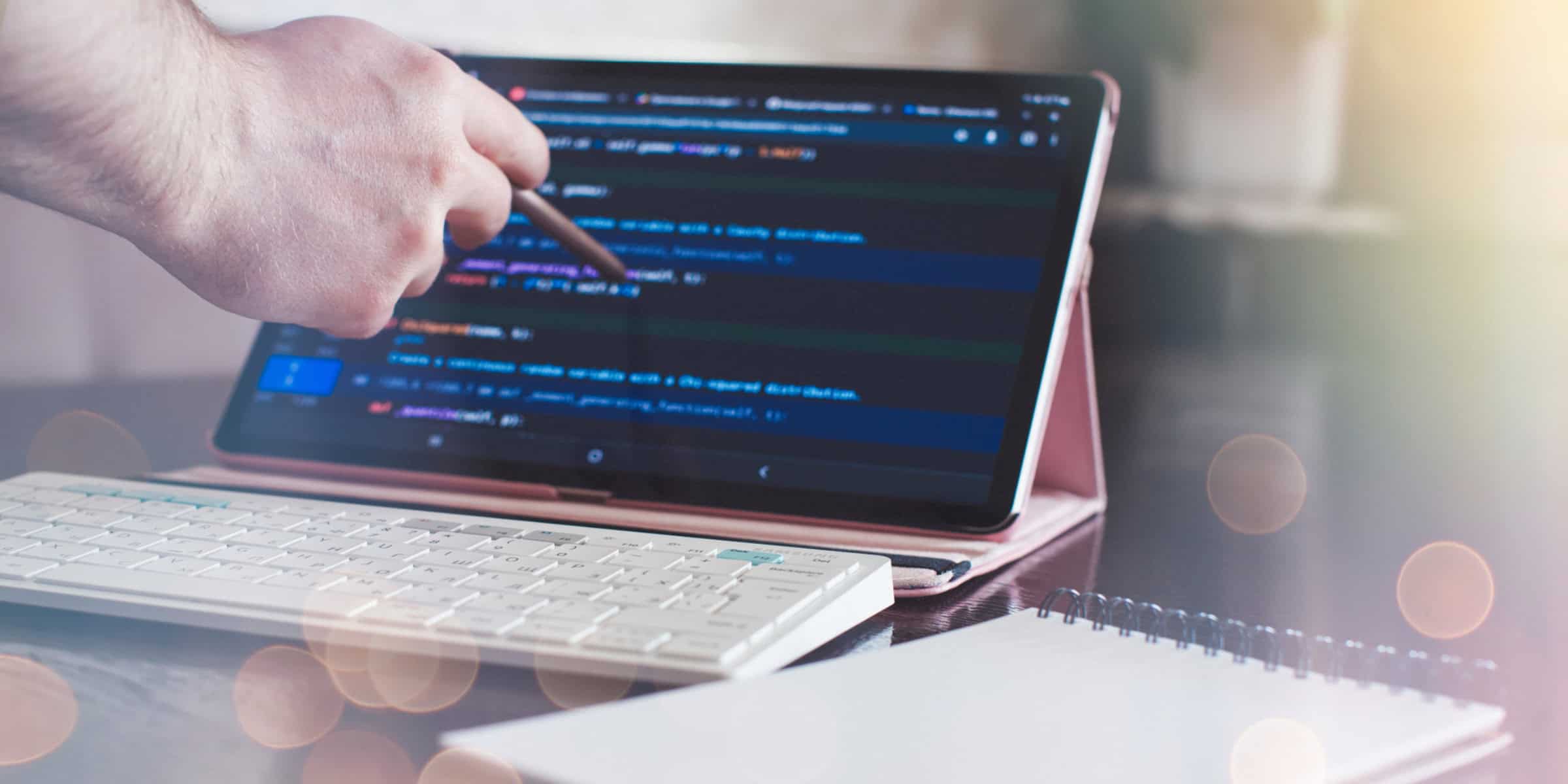 A person typing on a tablet computer with a keyboard.