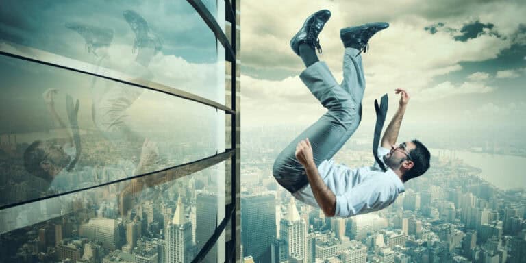 A man falling out of a window of a building.