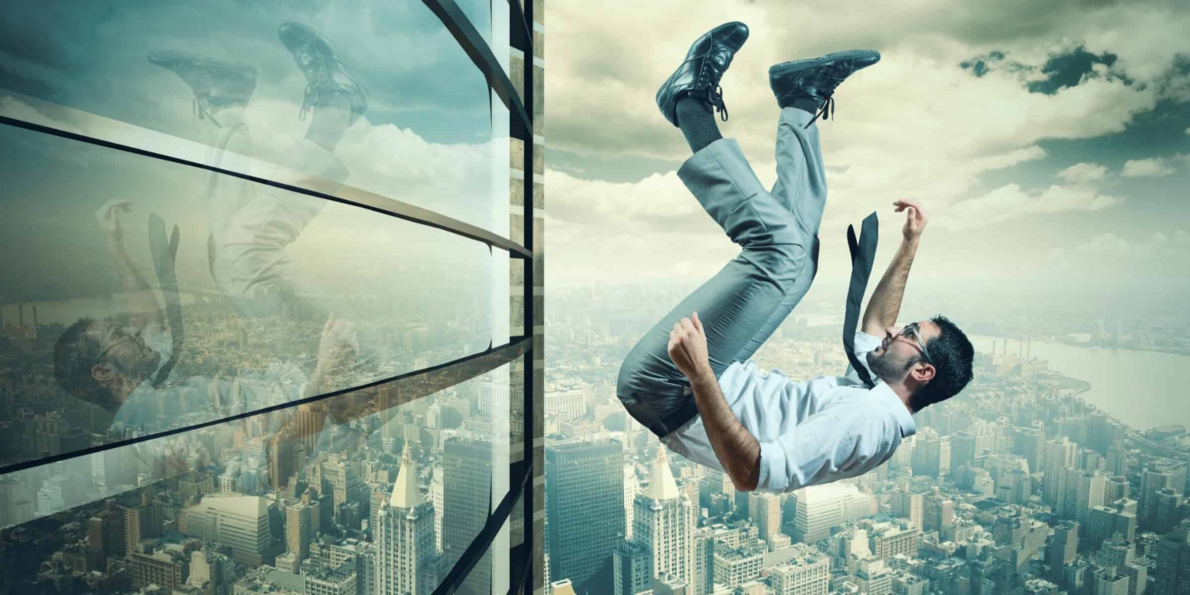A man falling out of a window of a building.