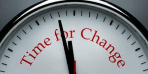 A clock with the words time for change on it.
