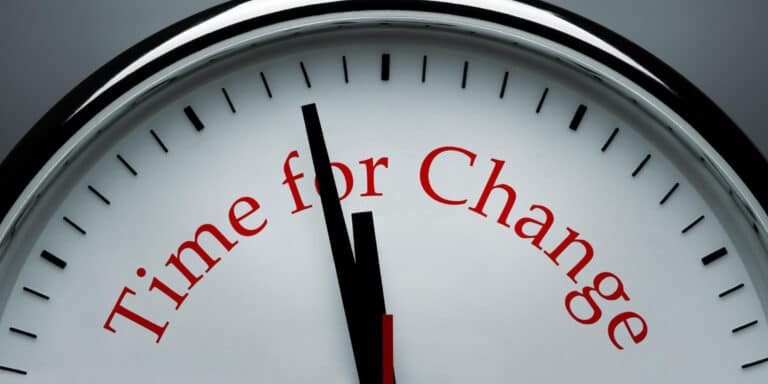 A clock with the words time for change on it.
