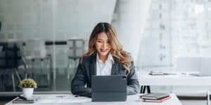 Asian business woman using a laptop in the office.