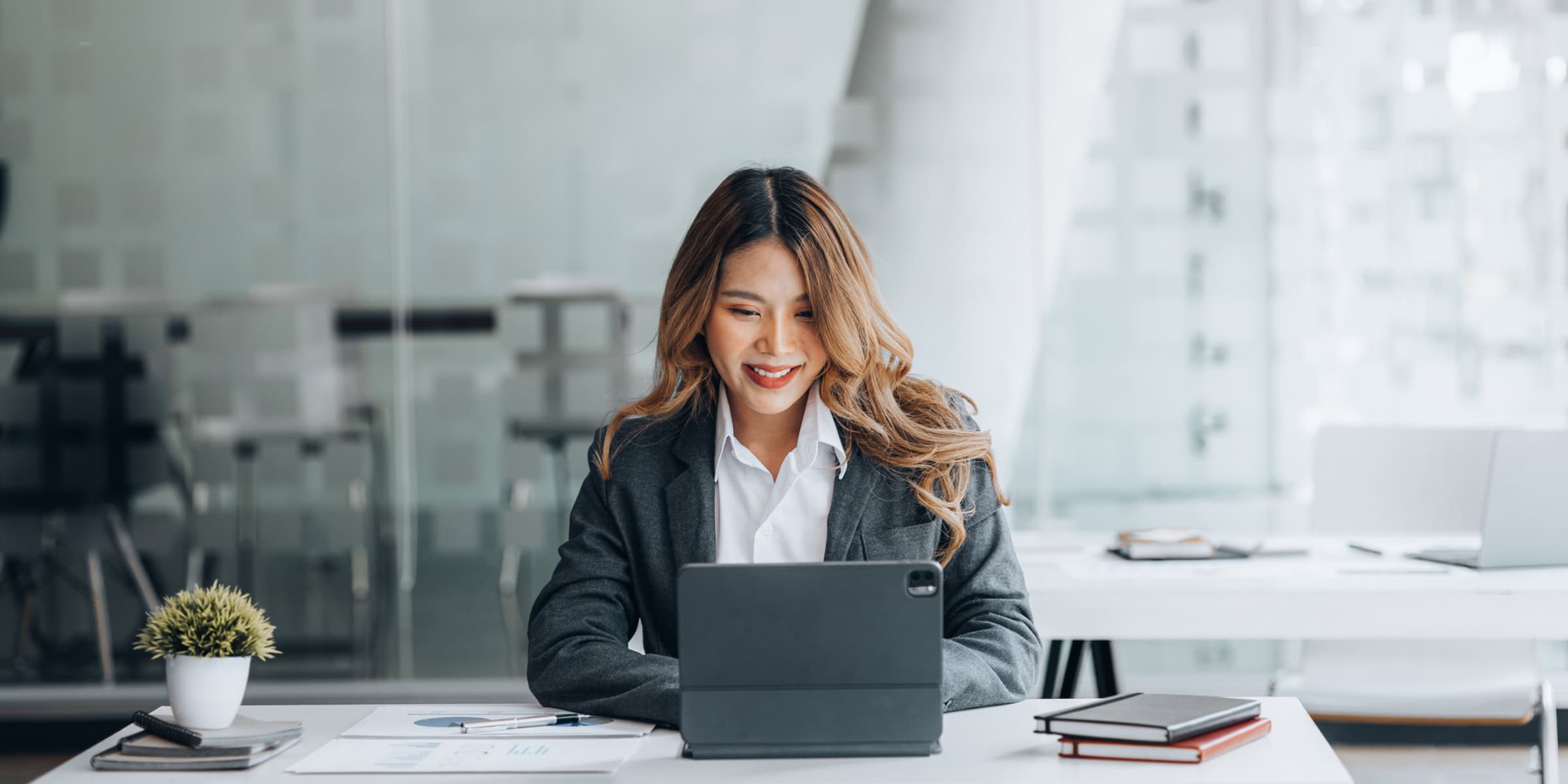 Asian business woman using a laptop in the office.