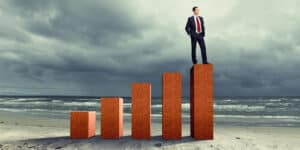 A man standing on a bar graph.