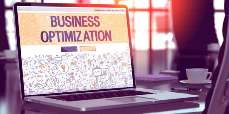 A laptop with the word business optimization on it.