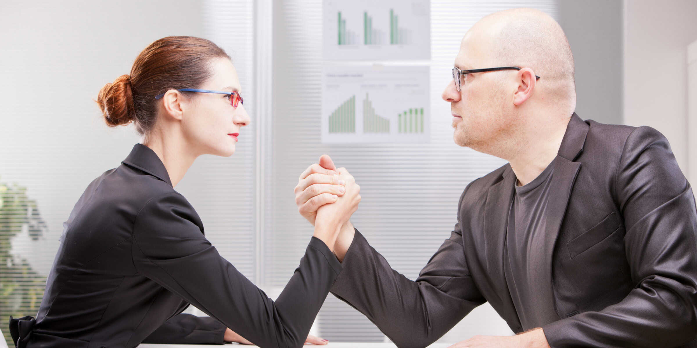 Two business people shaking hands in an office.