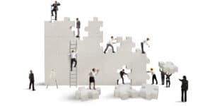 A group of business people working on a puzzle piece.