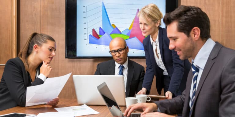 A group of business people in a meeting room.