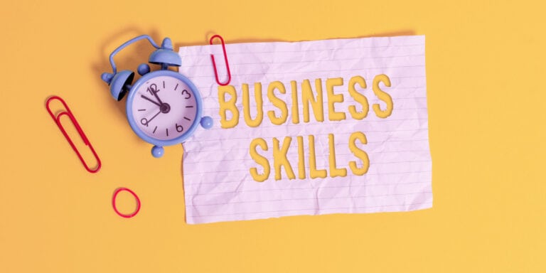Business skills on a yellow background with a clock.
