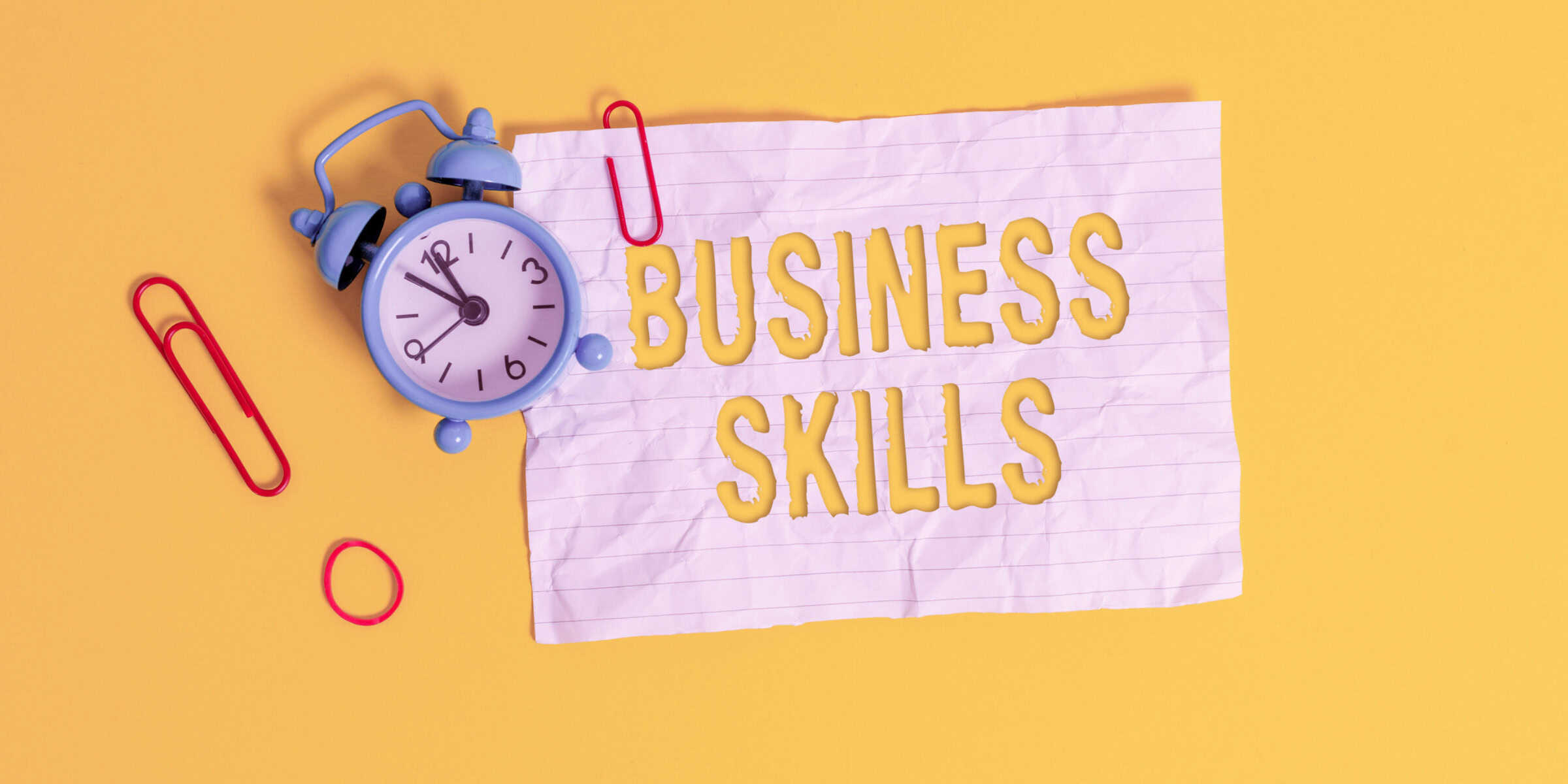 Business skills on a yellow background with a clock.