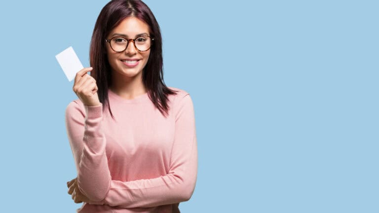 A woman holding a blank business card.