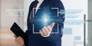 A man in a suit is holding a tablet computer.