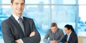 A businessman standing in front of a group of people.