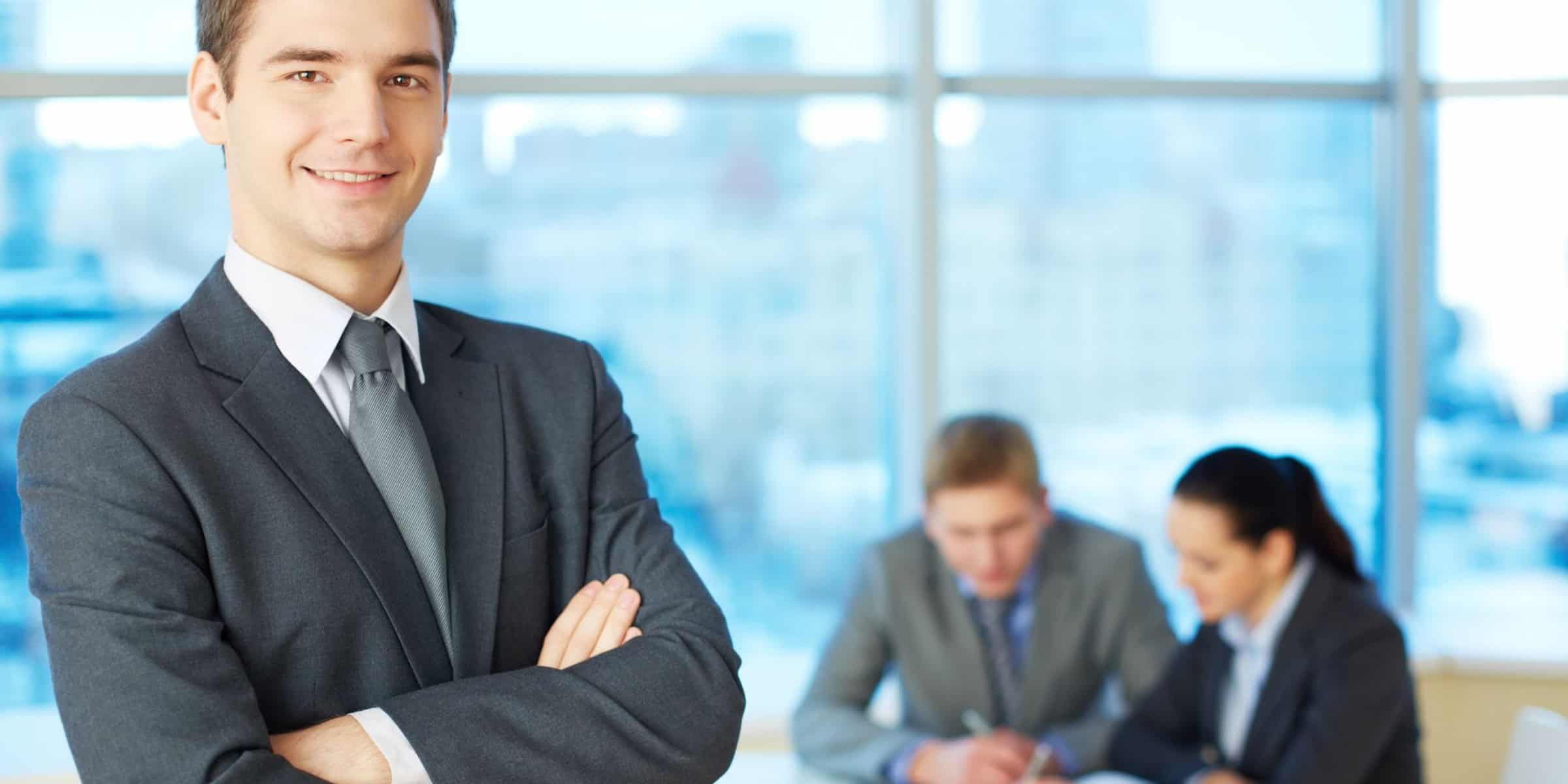 A businessman standing in front of a group of people.