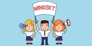 A cartoon illustration of a group of people holding up a sign that says mindset.