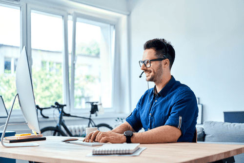 A man sitting at a desk working on his computer.