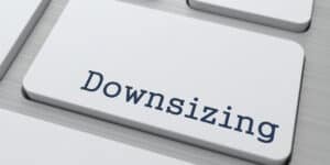 Close-up of a keyboard button labeled "downsizing" in a modern, clean font on a white key.