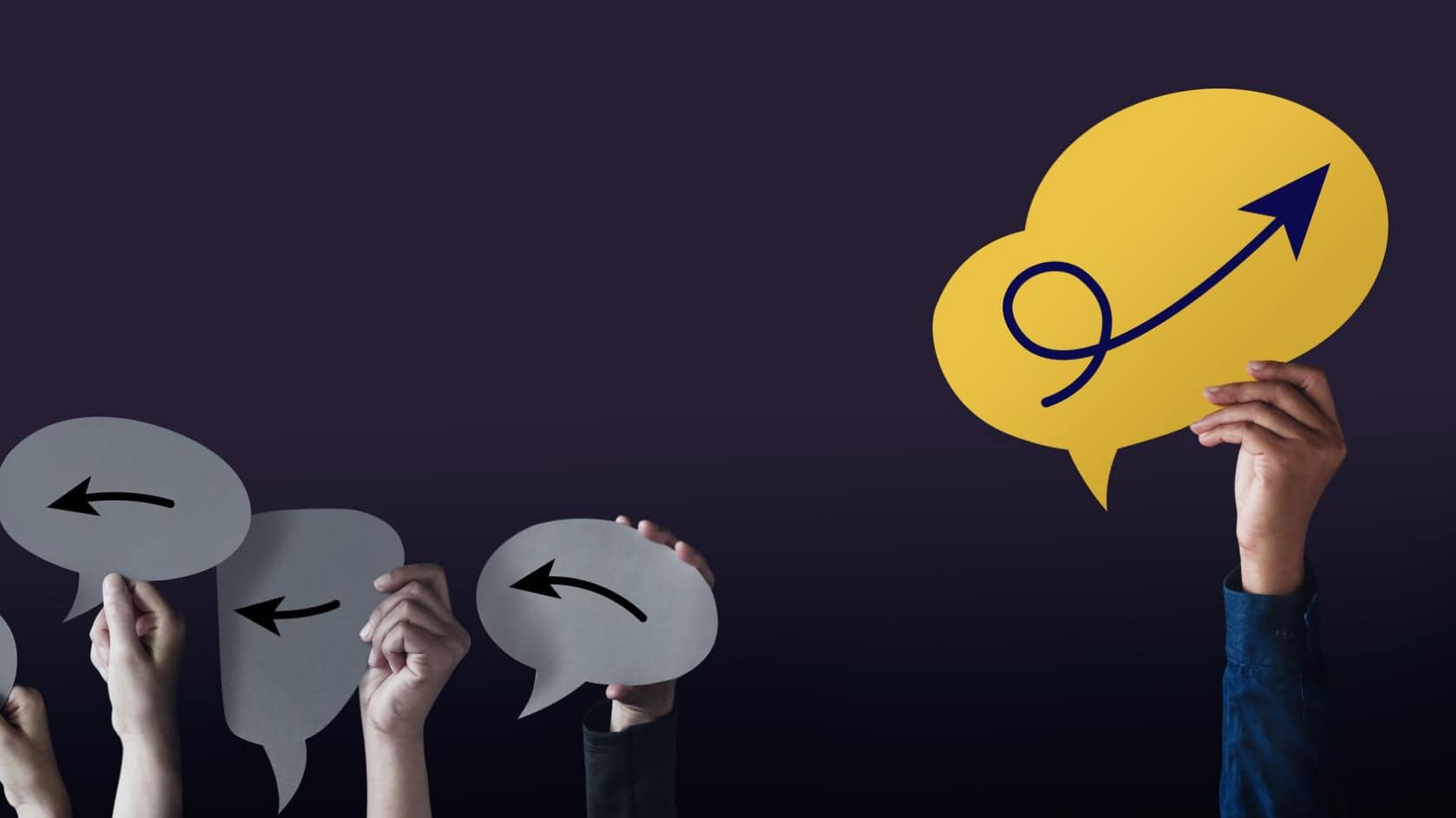 A group of people holding up speech bubbles with arrows on them.