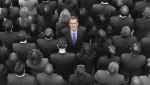 A man standing in the middle of a crowd of people.