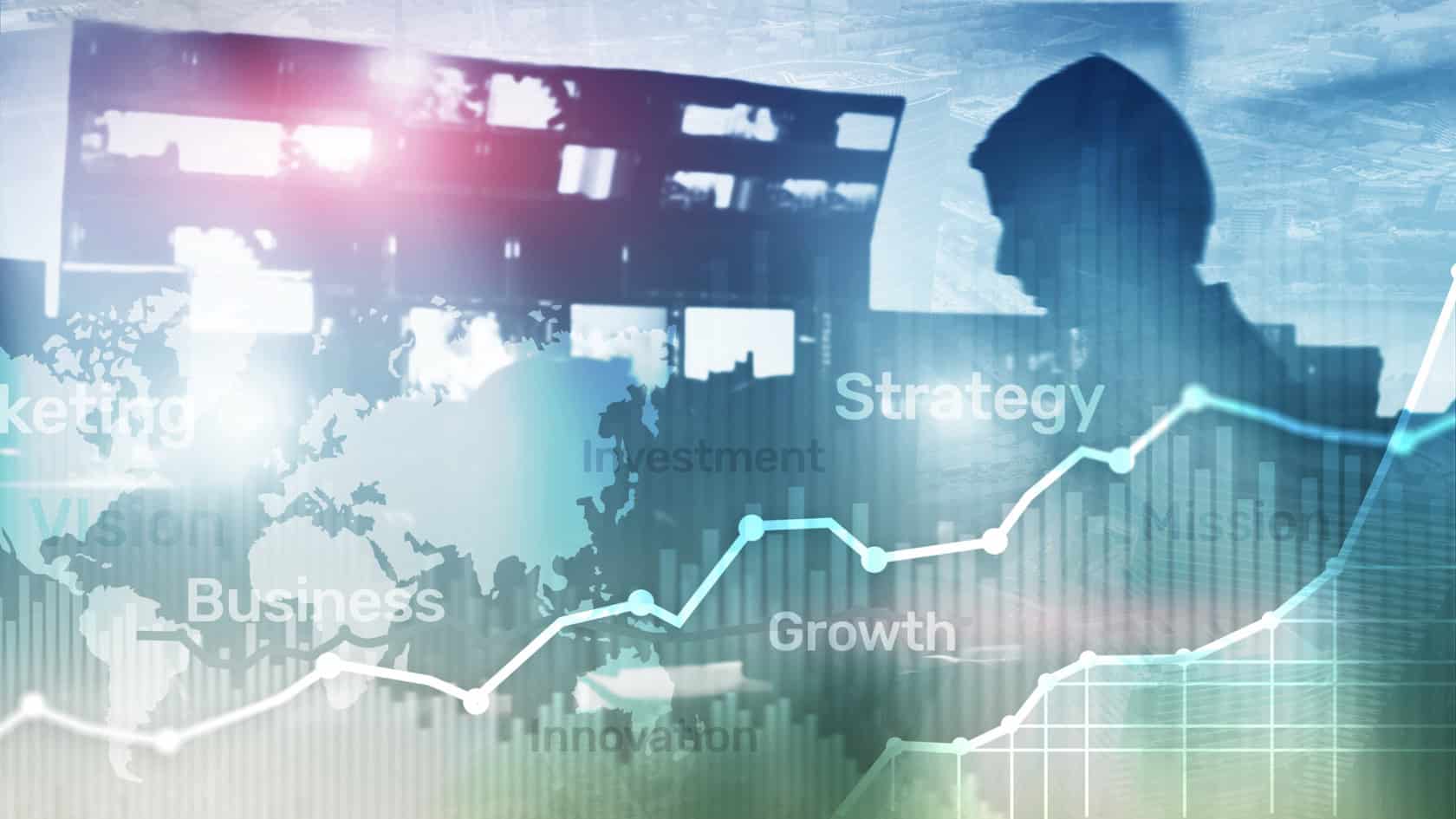 A man is standing in front of a business graph.