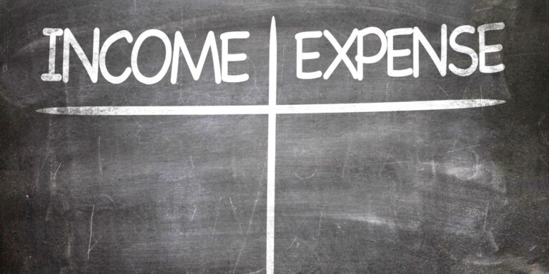 A chalkboard with the word income expense written on it.