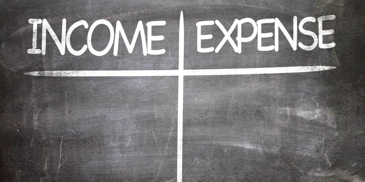 A chalkboard with the word income expense written on it.
