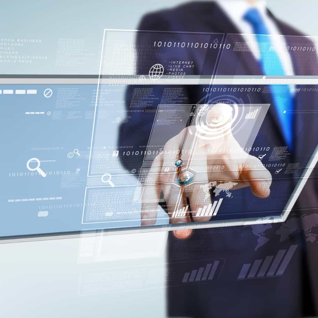 A person in a suit interacts with digital interfaces, featuring graphs, binary code, and technical icons, against a futuristic transparent screen background.