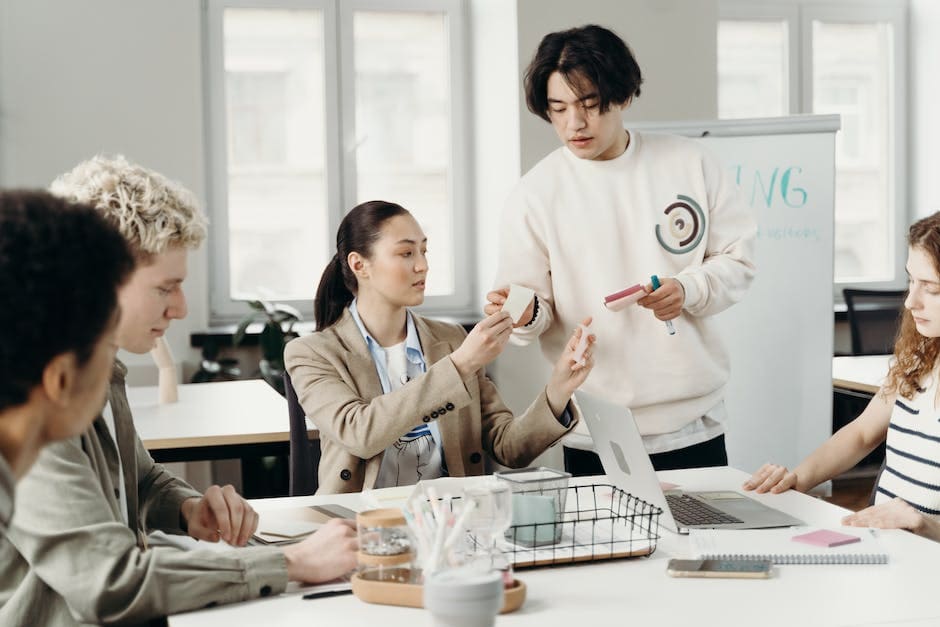 A team of people standing around a table, discussing ideas and strategies for change management.